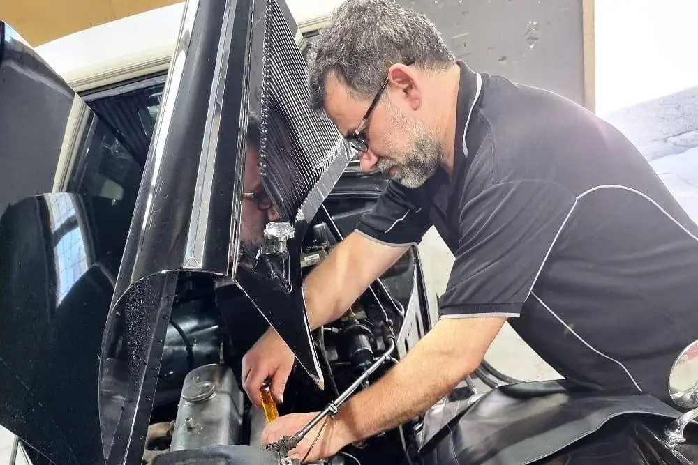 Mechanic maintaining a vehicle at Finch